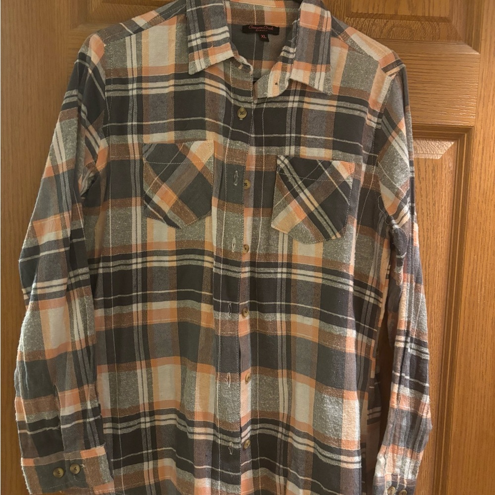 Peach and Gray Flannel. Size XL but fits like a medium.